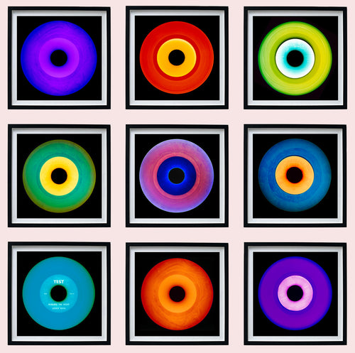 Photograph by Heidler and Heeps. Nine colourful vinyl records appearing in a 3 x 3 format.