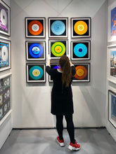 Load image into Gallery viewer, Photograph by Heidler and Heeps. In situ, nine colourful vinyl records appearing in a 3 x 3 format.
