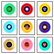 Load image into Gallery viewer, Photograph by Heidler and Heeps. A selection of 9 B side vinyl disks, set in white mounts, with black frames. Mounted in a 3x3 square.