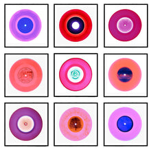 Load image into Gallery viewer, Photograph by Heidler and Heeps. A selection of 9 pink vinyl disks, set in white mounts, with black frames. Mounted in a 3x3 square.