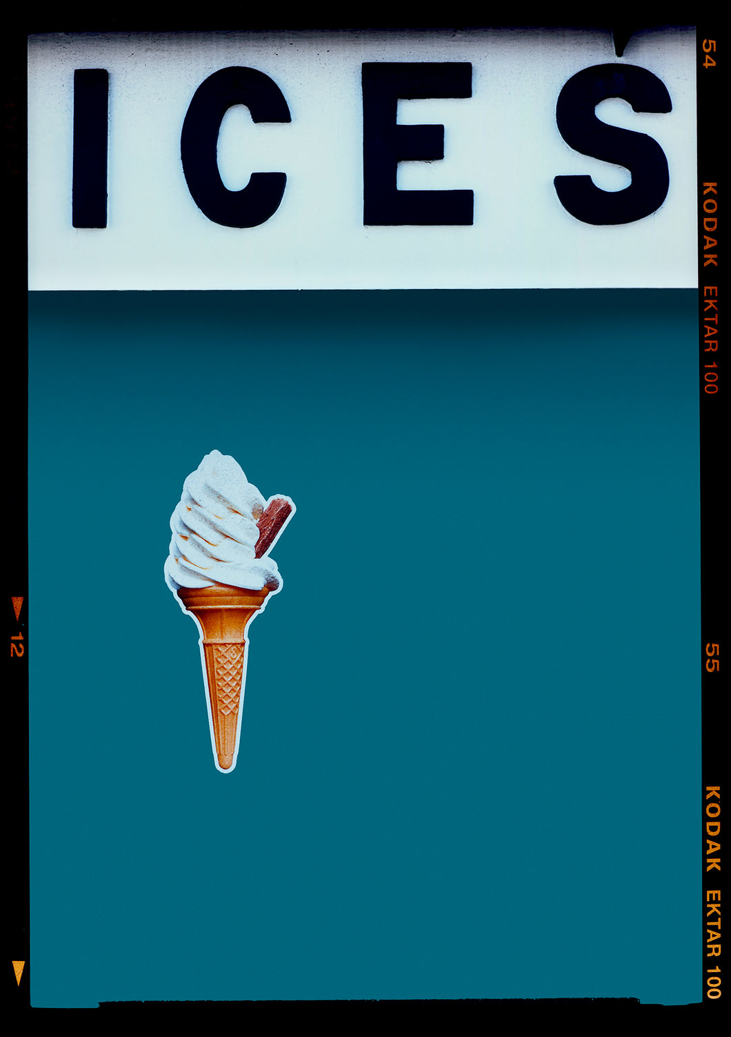 Photograph by Richard Heeps.  At the top black letters spell out ICES and below is depicted a 99 icecream cone sitting left of centre against a blue teal coloured background.  