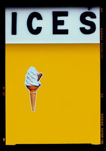 Photograph by Richard Heeps.  At the top black letters spell out ICES and below is depicted a 99 icecream cone sitting left of centre against a mustard yellow coloured background.  