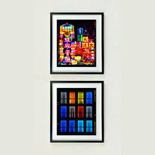 Load image into Gallery viewer, Two framed artworks by Richard Heeps on a white wall, one with colorful cityscape and the other with grid of colored squares.