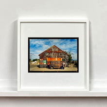 Load image into Gallery viewer, Model T and Garage American road trip colour Kodak Film photograph by Richard Heeps mounted square framed in white.