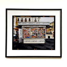 Load image into Gallery viewer, News Stand Milan, Italian street photography by Richard Heeps print framed in black.