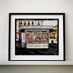 News Stand Milan, Italian street photography by Richard Heeps small print framed in black.