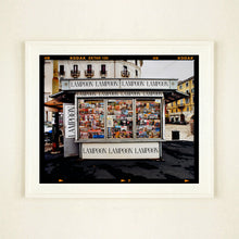 Load image into Gallery viewer, News Stand Milan, Italian street photography by Richard Heeps large print framed in white.