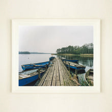 Load image into Gallery viewer, Ormesby Little Broad, a docking jetty with small boats stretches out to the Norfolk Broad photograph by Richard Heeps large framed in white.