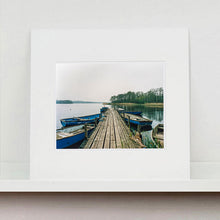 Load image into Gallery viewer, Ormesby Little Broad, a docking jetty with small boats stretches out to the Norfolk Broad photograph by Richard Heeps mounted square.