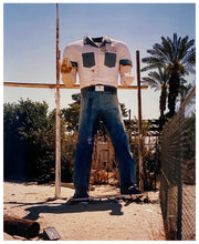 Load image into Gallery viewer, Photograph by Richard Heeps. The headless torso of a giant fibreglass sculpture of a cowboy (a Muffler Man).