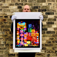 Load image into Gallery viewer, Richard Heeps holding Lights of Mong Kok Hong Kong print.