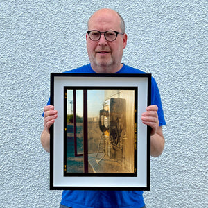 Richard Heeps holding Call Box photograph in a small black frame