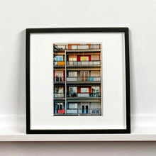 Load image into Gallery viewer, Black framed photograph by Richard Heeps. A colourful set of walls and balconies over five floors.