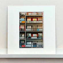 Load image into Gallery viewer, Mounted photograph by Richard Heeps. A colourful set of walls and balconies over five floors.