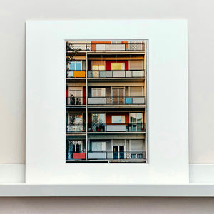 Mounted photograph by Richard Heeps. A colourful set of walls and balconies over five floors.
