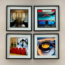 Load image into Gallery viewer, Four black framed photographs by Richard Heeps. Photographs of the inside of a subway car, the inside of a Wimpy in Norfoik. Bottom right is the photo of a vinyl record on a retro record player, bottom left is a photograph of 4 red retro chairs in a hair salon.