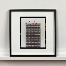 Load image into Gallery viewer, Black framed photograph by Richard Heeps. High rise offices with Martini lgoo on the top facade. 