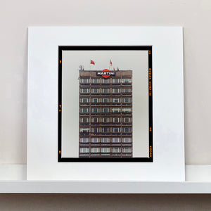 White mounted photograph by Richard Heeps. High rise offices with Martini logo on the top facade. 