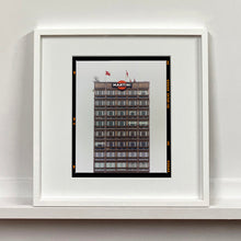 Load image into Gallery viewer, White framed photograph by Richard Heeps. High rise offices with Martini logo on the top facade. 