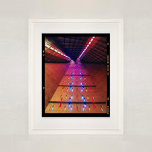 Load image into Gallery viewer, White framed photograph by Richard Heeps. Stained glass windows on the interior of San Giovanni Bono Church, a concrete brutalist building in Milan by Italian architect Arrigo Arrighetti. 