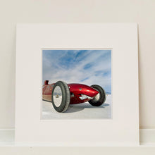 Load image into Gallery viewer, Mounted photograph by Richard Heeps.  The side on front of a red belly tank racing car, it is designed as a shark eating a $100 bill.