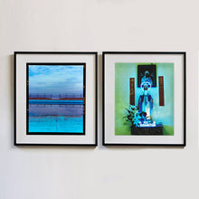Load image into Gallery viewer, Two photographs by Richard Heeps. The photograph on the left hand side depicts the blue bay at Llandudno, cut across the middle with path and railings with a gap right in the middle. The photograph on the right hand side is a neon lit Virgin Mary, with the words &quot;Ave Maria&quot; lit in Neon at the statues feet, the photograph is in a green and blue toned view.