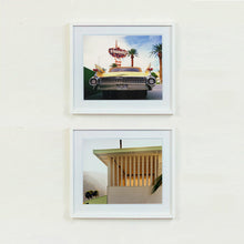 Load image into Gallery viewer, Two white framed photographs by Richard Heeps.  The top photograph features the back end of the classic American car with a number place DREAM01 sits underneath the STARDUST casino sign. The photo at the bottom features a cream building with a big window with vertical blinds, a palm frond appears from the right hand side and to the left of the building in the distance are misty covered mountains and trees.