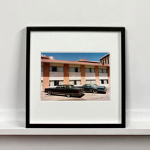 Load image into Gallery viewer, Black framed photograph by Richard Heeps. This retro photograph has two classic Lincoln cars parked outside a hotel in Las Vegas. 
