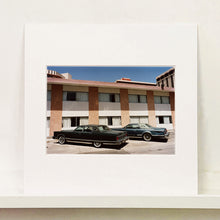 Load image into Gallery viewer, Mounted photograph by Richard Heeps. This retro photograph has two classic Lincoln cars parked outside a hotel in Las Vegas. 