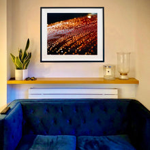Load image into Gallery viewer, In situ photograph by Richard Heeps. The photograph is of a brown metal surface with water droplets on. The lighting makes the droplets appear in different colours of orange and brown.