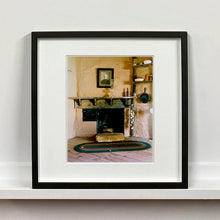 Load image into Gallery viewer, Black framed photograph by Richard Heeps. Film set of &#39;The Outlaw Josey Wales&#39; featuring a wooden fireplace and a black and white photo over the mantlepiece.