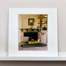 Load image into Gallery viewer, Mounted photograph by Richard Heeps. Film set of &#39;The Outlaw Josey Wales&#39; featuring a wooden fireplace and a black and white photo over the mantlepiece.