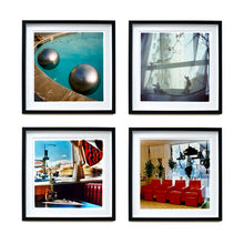 Load image into Gallery viewer, 4 Black framed photographs by Richard Heeps. The top left hand photograph is of the corner of a circular swimming pool with two metallic silver beach balls floating on the water. The top right photo is ceramic figures sitting on a windowsill. The bottom left hand photo is a booth in an American diner, the bottom right is red chairs lined up in a barbers.