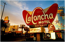 Load image into Gallery viewer, Photograph by Richard Heeps. This photograph is of the outside of La Concha Motel. The gold flamboyant La Concha lettering is set on a big red background. Below the motel sign is NO VACANCY with just VACANCY lit in red, below this sits a sign for Budget rent a car. Other signs and palm trees are the background together with a blue sky.