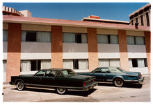 Load image into Gallery viewer, Photograph by Richard Heeps. This retro photograph has two classic Lincoln cars parked outside a hotel in Las Vegas. 