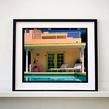 Load image into Gallery viewer, Black framed photograph by Richard Heeps. Palm Springs Pool Side II showcases classic mid-century Palm Springs California architecture. Cool blue skies and pool with accents of pink and almost neon yellow. 