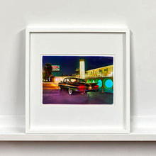 Load image into Gallery viewer, White framed photograph by Richard Heeps. A Chevy Bel Air is central shot and off to the right are the pools and balcony of the Glass Pool Motel, Las Vegas.
