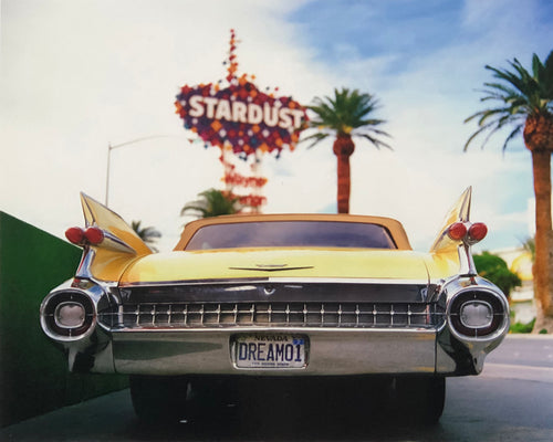 Photograph by Richard Heeps.  The back end of the classic American car with a number place DREAM01 sits underneath the STARDUST casino sign.