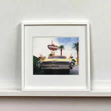Load image into Gallery viewer, White framed photograph by Richard Heeps.  The back end of the classic American car with a number place DREAM01 sits underneath the STARDUST casino sign.