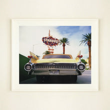 Load image into Gallery viewer, White framed photograph by Richard Heeps.  The back end of the classic American car with a number place DREAM01 sits underneath the STARDUST casino sign.