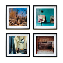 Load image into Gallery viewer, Four black framed photographs in a square by Richard Heeps. The top photograph is of a reed tuft sticking out of a blurred reed bed. The next photograph is a blue shelf, with blue wrinkled wallpaper behind. On the shelf sits a small posy, mirror and cat magazine. The third photograph is a old and worn sink and taps. The fourth photograph is a chalk board with Work Pending chalked on top and the writing beneath rubbed out.
