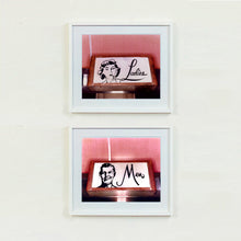 Load image into Gallery viewer, 2 white framed photographs by Richard Heeps. Two kitsch toilet signs. Both photographs have a sign one with the word Ladies and one with Men which sits alongside an outline of 1950s woman and man respectively. The signs sit in a wooden frame against a pink tiled wall.