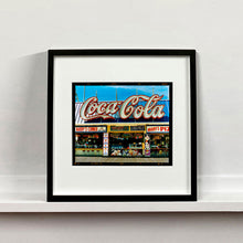 Load image into Gallery viewer, Black framed photograph by Richard Heeps. Harry&#39;s Corner was taken on the wildwood boardwalk, featuring neon typography and the iconic Coca-Cola sign against a bright blue sky. 