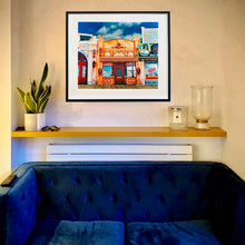 Load image into Gallery viewer, La Belle Femme in the Sun framed in black on the living room wall.