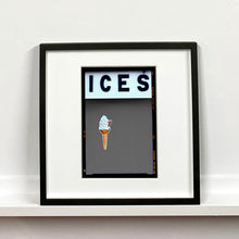 Load image into Gallery viewer, Black framed photograph by Richard Heeps.  At the top black letters spell out ICES and below is depicted a 99 icecream cone sitting left of centre against a grey coloured background.  