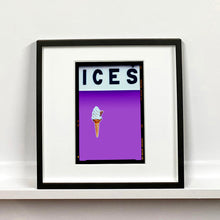 Load image into Gallery viewer, Black framed photograph by Richard Heeps.  At the top black letters spell out ICES and below is depicted a 99 icecream cone sitting left of centre against a lilac coloured background.  
