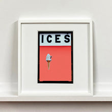 Load image into Gallery viewer, White framed photograph by Richard Heeps.  At the top black letters spell out ICES and below is depicted a 99 icecream cone sitting left of centre against a melondrama red orange coloured background.  