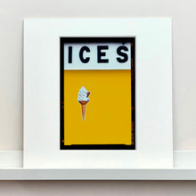 Load image into Gallery viewer, Mounted photograph by Richard Heeps.  At the top black letters spell out ICES and below is depicted a 99 icecream cone sitting left of centre against a mustard yellow coloured background.  