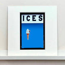 Load image into Gallery viewer, Mounted photograph by Richard Heeps.  At the top black letters spell out ICES and below is depicted a 99 icecream cone sitting left of centre against a sky blue coloured background.  