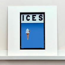 Load image into Gallery viewer, Mounted photograph by Richard Heeps.  At the top black letters spell out ICES and below is depicted a 99 icecream cone sitting left of centre against a Baby Blue coloured background.  